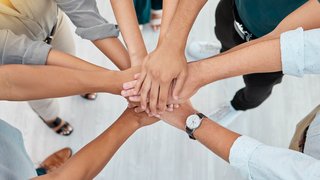 Support, trust and collaboration of business people pile hands together in agreement of partnership in an office. Teamwork, team building and celebrating company growth and diversity