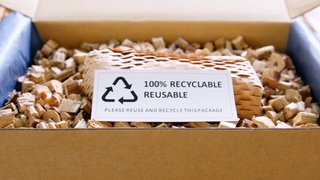 Net zero waste go green SME use eco friendly care sign plastic free symbol packaging carton box wrap paper in small shop retail store. Chva dried water hyacinth on desk reuse packing parcel supplies.