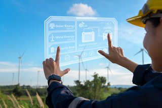 Close up engineering woman hand is touching virtual reality Analytics engineering data in a field over electrical turbines background