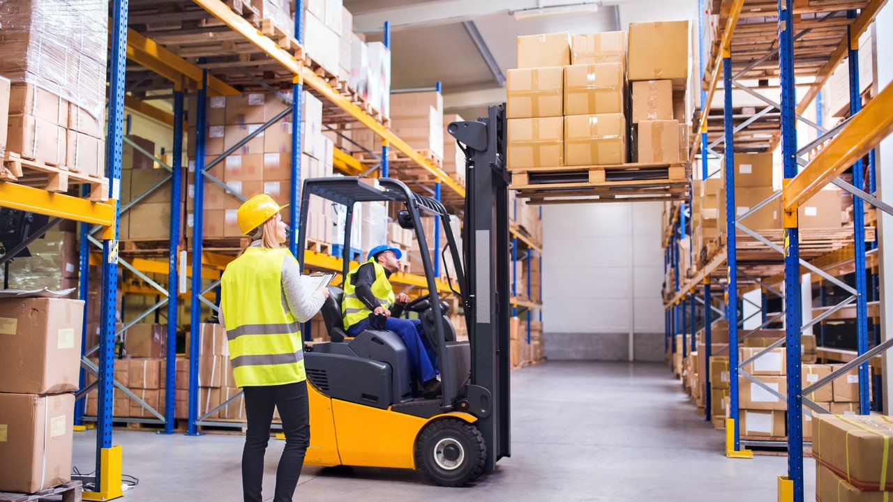 Young warehouse workers working together.