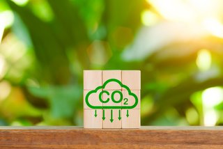 Reduce Co2 Emissions concept. Carbon reduction icon on wooden cube for decrease CO2. Carbon neutral, Net Zero, Climate change, Sustainable energy, Carbon footprint, environmental problems, neutrality,